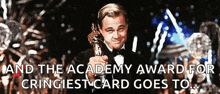 a man in a tuxedo is holding an oscar statue in front of a crowd