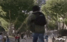 a group of people are walking down a set of stairs in a park .