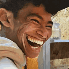 a close up of a man 's face laughing with his mouth open