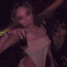 two women are standing next to each other in a dark room .