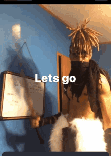 a man with dreadlocks is holding a sword in front of a white board that says lets go