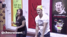 a man and a woman are dancing in front of a poster that says stay germ free