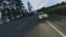 a yellow car is driving down a road with a yellow line