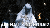 a man sitting in a chair with the words all hail king noraiz