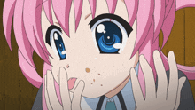 a girl with pink hair and blue eyes is making a face