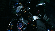 a blurred image of a person 's arm with a purple and red ring around it