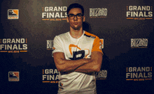 a man stands in front of a wall that says grand finals on it