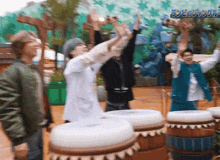 a group of people with their arms in the air and a sign that says ' jungle ' on it