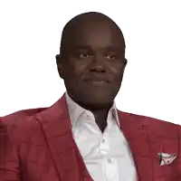 a man wearing a red suit and a white shirt is smiling