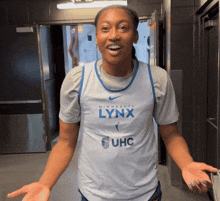 a woman wearing a jersey that says minnesota lynx and uhc