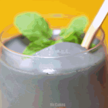 a close up of a drink with a spoon in it and the words mr.cakes below