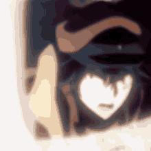 a blurred image of a person 's face with a white heart in the middle