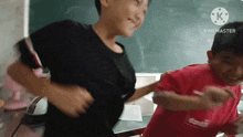 two boys are dancing in front of a blackboard and the words kinemaster are on the bottom right