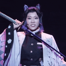 a woman in a butterfly costume is holding a large sword