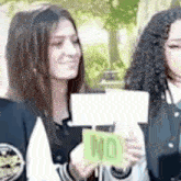 a woman is holding a sign that says `` no '' in her hands .