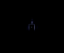 a person is standing in a dark hallway with a light coming from the ceiling .