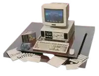 a computer with monkey island on the screen sits on a desk