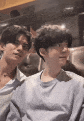 a couple of young men sitting next to each other