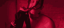 a close up of a person 's face in red light .