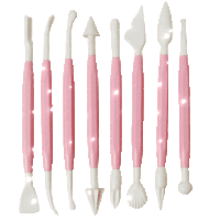 a row of pink and white plastic utensils on a white surface