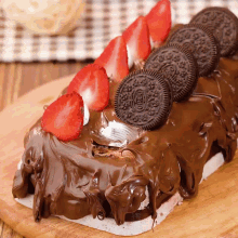 a chocolate cake with oreo cookies and strawberries
