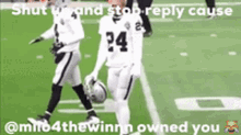 two football players are walking on a field and one has the number 34 on his jersey