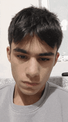 a close up of a young man 's face with his eyes closed