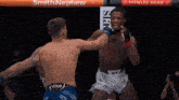 two men are fighting in a cage with a sign that says howler head on it