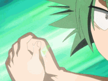 a close up of a person 's hand with green hair