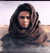 a man is wearing a scarf around his head