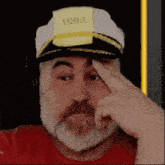 a man with a beard wearing a captain 's hat with a note on it that says train