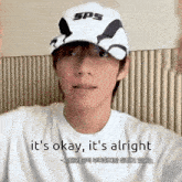 a man wearing a sps hat says it 's okay and it 's alright