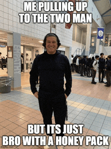 a man standing in a hallway with a caption that says me pulling up to the two man but it 's just bro