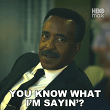 a man in a suit and tie is saying " you know what i 'm sayin "