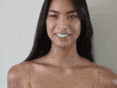 a close up of a woman 's face without makeup and smiling .