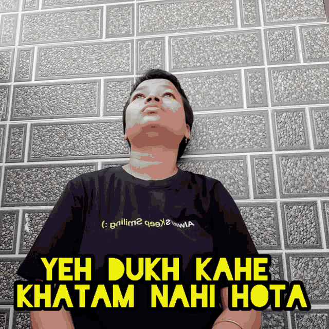 a person wearing a black shirt that says yeh dukh kahe khatam nahi hota