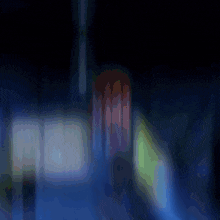 a blurry picture of a person in a blue room