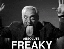 a black and white photo of a man sticking his tongue out and the words absolute freaky behind him