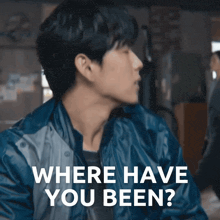 a man in a blue jacket stands in front of a woman holding a punching bag and the words " where have you been "