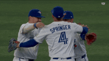 a baseball player with the number 18 on his back hugging another player