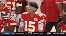 a football player wearing a red jersey with the number 15
