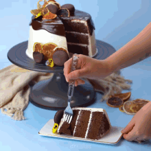 a person is taking a slice of cake with a fork