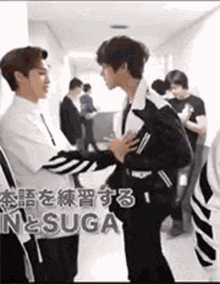 a group of men are standing next to each other in a hallway .