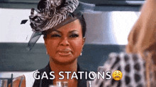 a woman wearing a zebra print hat is crying while talking to another woman .