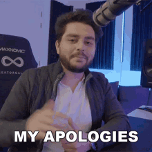 a man sitting in front of a microphone says my apologies