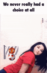 a woman in a red shirt is laying down with a soccer ball and a flag with the manchester united logo on it