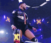 a wrestler wearing a black jacket that says page on it