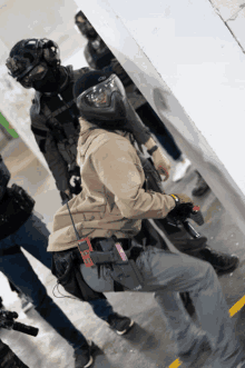 a man wearing a helmet and goggles has a gun holster that says ' lg ' on it