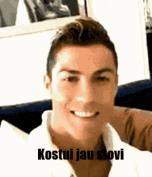 a close up of a man 's face with the words kostiui jau stovi above him