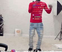 a man wearing a red shirt that says illuminati